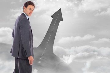 Poster - Composite image of serious businessman with hand on hip