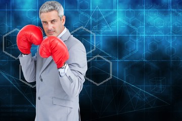 Poster - Composite image of tough businessman with boxing gloves