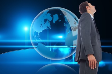Poster - Composite image of cheerful handsome businessman standing