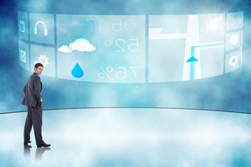 Poster - Composite image of serious businessman with hands on hips