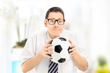 Wall Mural - Anxious young sports fan watching football match