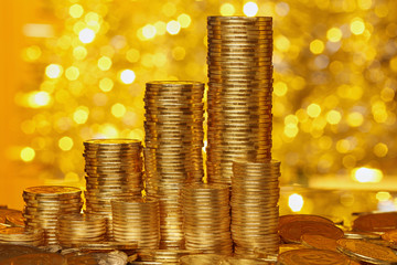 Coins stack on golden bokeh background