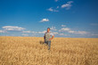 © Ryzhkov Oleksandr - Happy smiling caucasian  old farmer standing in wheat fields