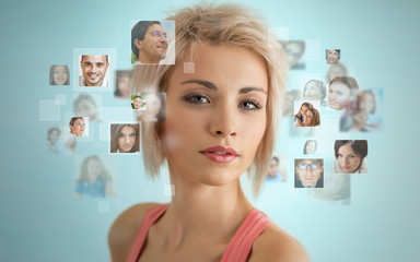 Young woman standing and smiling with many different people's fa