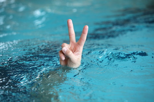 victory or peace symbol,above water surface - body language