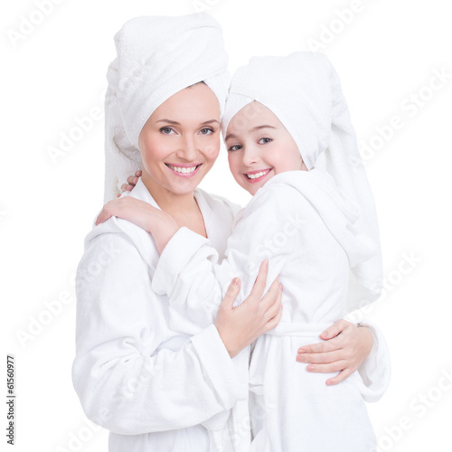 Fotografie, Obraz happy mother and young daughter in white dressing gown