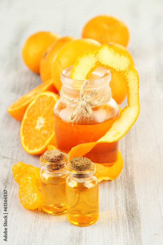 Tangerine essential oil and tangerines on wooden table