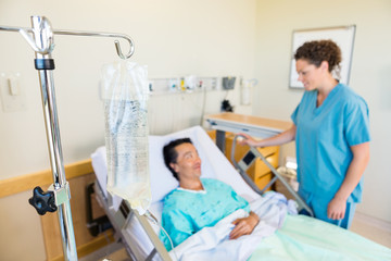 Wall Mural - IV Bag With Nurse And Patient Looking At Each Other