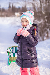 Sticker - Little adorable happy girl in the snow sunny winter day