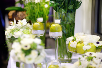 Beautiful bouquet of green apples and a candles