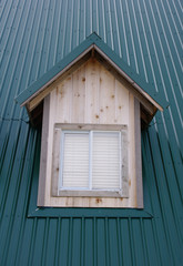 Wall Mural - dormer with windows on the dark green roof