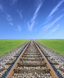 © smuki - Railway track, green grass and blue sky on the horizon