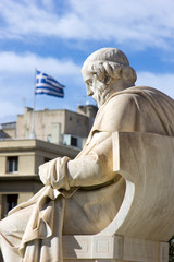 historic greek statue with greek flag on the background