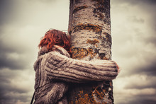 Woman Hugging A Tree