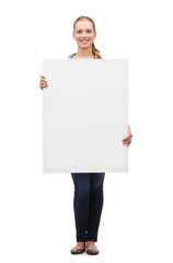 smiling young woman with white blank board