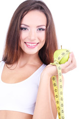 Poster - Beautiful young woman with green apple and measuring tape