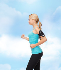 Poster - sporty woman running with smartphone and earphones