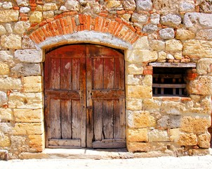Fototapete - Medieval stone house with rustic door, Tuscany, Italy