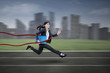 © Creativa Images - Businesswoman winning on a race