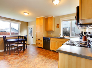 kitchen and dining table with green walls and maple cabinets
