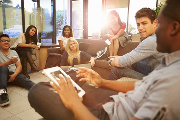 Group Of University Students Relaxing In Common Room