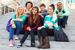 © Monkey Business - Portrait Of High School Students Sitting Outside Building