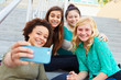 © Monkey Business - Female High School Students Taking Selfie Photograph