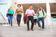 © Monkey Business - High School Pupils And Teacher On Steps Outside Building