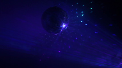 Wall Mural - Rotating disco ball with multicolor light effect and dense smoke