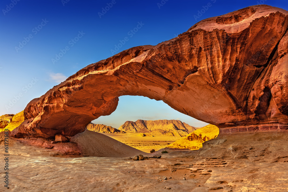View through a rock arch in the desert of Wadi Rum - obrazy, fototapety, plakaty 