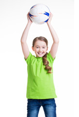 Wall Mural - Smiling little girl lifted up the ball.