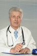 © aletia2011 - Elderly doctor at a table