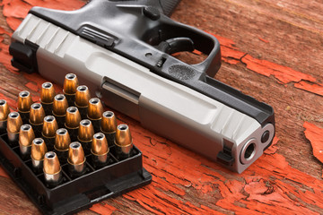 Close up of a handgun and rack of ammunition