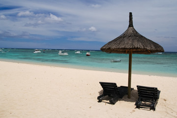 Umbrella with two chairs on the beach