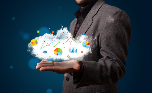 Young businessman presenting cloud with charts and graph icons a