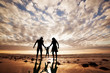 © Photocreo Bednarek - Happy family together hand in hand on the beach at sunset.
