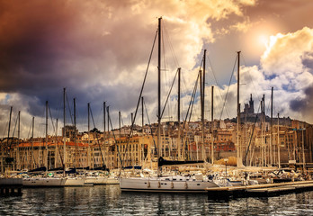 Wall Mural - view of the city and sea port on the background of dramatic suns