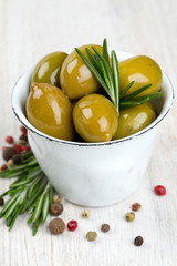 Poster - green olives in a metallic cup on wooden surface