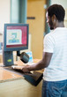 © Tyler Olson - Librarian Scanning Books At Bookstore Counter