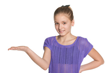 Smiling preteen girl makes a hand gesture