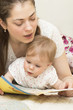© oksana6170 - The mother reads the book to the baby.