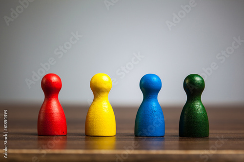 Fotografie, Obraz Four pawn figurines, team concept, table, grey background