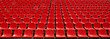 Rows of red football stadium seats with numbers.