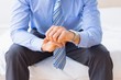 © WavebreakmediaMicro - Businessman sitting on bed checking the time