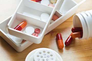 Pills and capsules sorted out in pillboxes