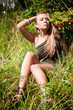 © Kyrylo Ryzhov - Sexy glamourous woman with blond hair sitting on grass at park