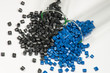 blue and black polymer pellets in test tubes