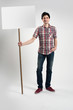 © spaxiax - happy Casual guy holding blank placard
