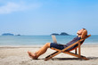 © Song_about_summer - happy business man with laptop relaxing on the beach
