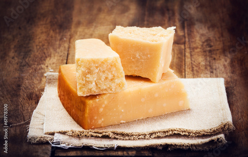 Fotografie, Obraz Italian Parmesan Cheese on Wooden Background close up. Piece of